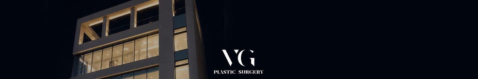 The VG Plastic Surgery building at night with its windows lit