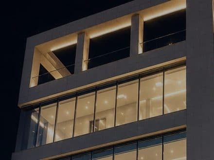 The VG Plastic Surgery building at night with its windows lit