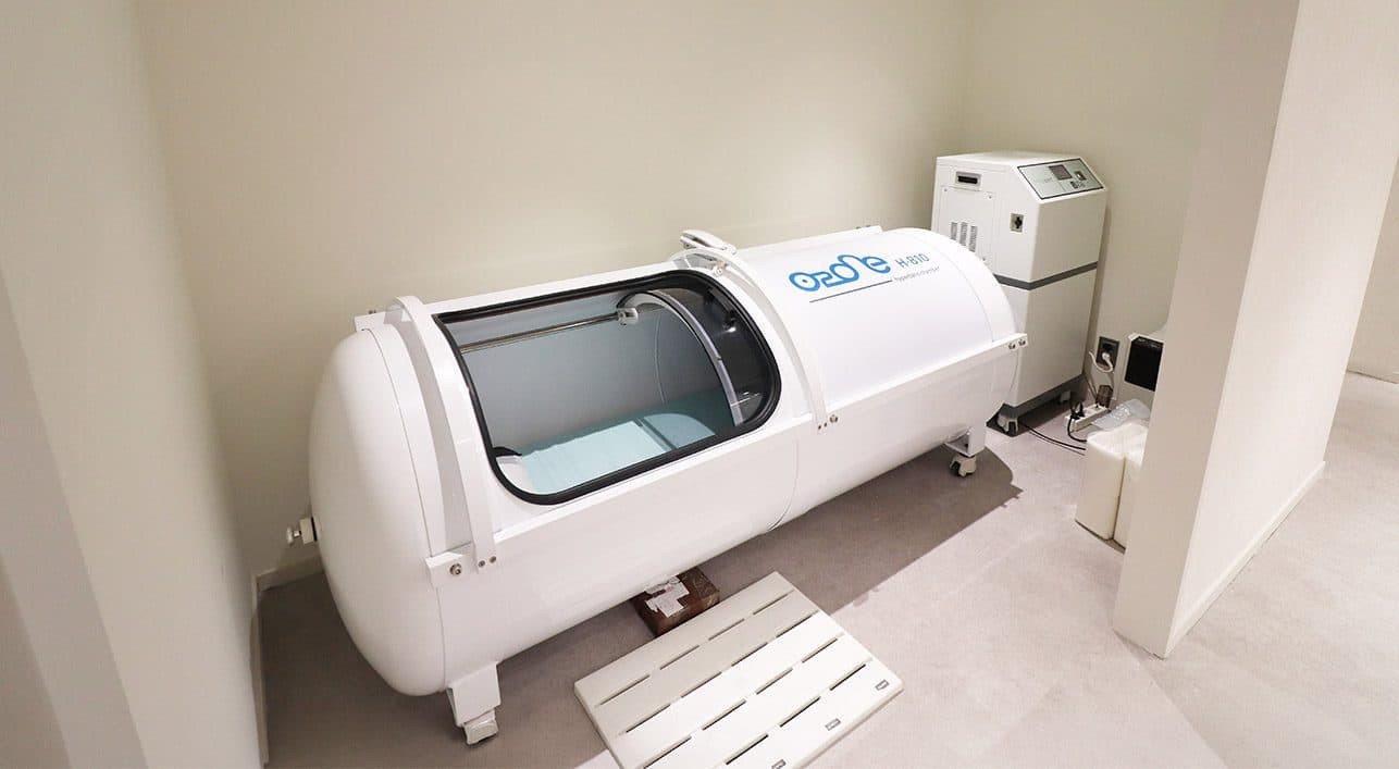 A hyperbaric oxygen chamber with its door open